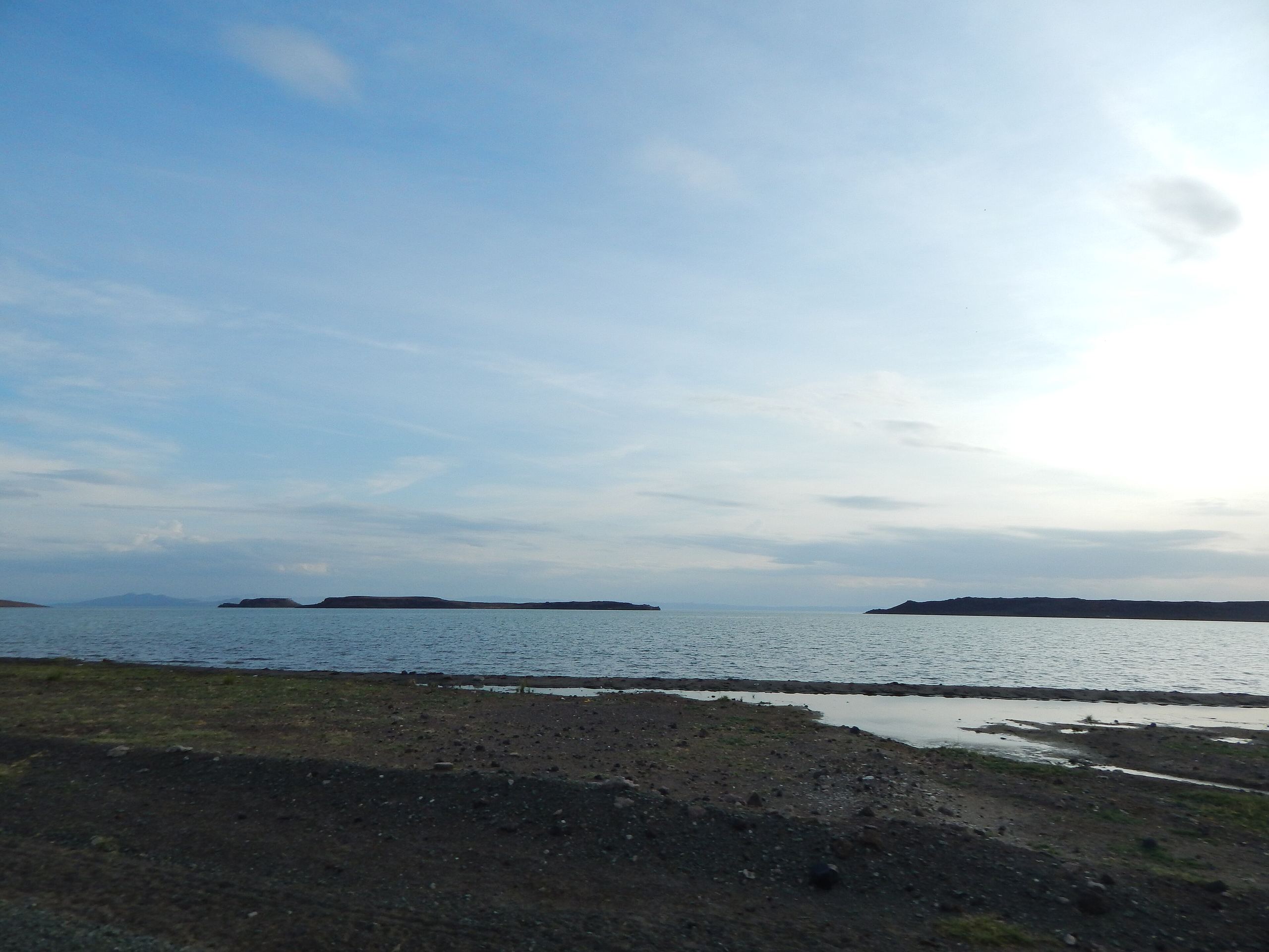 The wide, shallow water of Lake Turkana, the far shore on the horizon